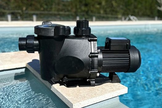 A pool pump and filter equipment set up beside a house