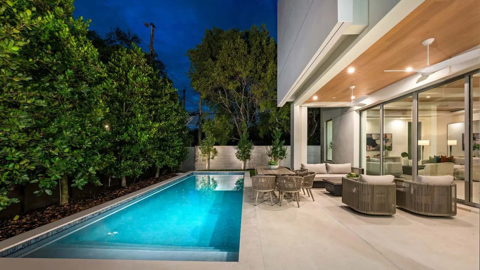 Contemporary Perth home with illuminated pool at dusk